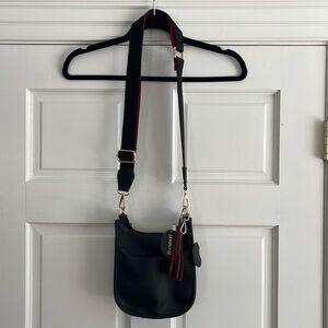 NWT vegan Crossbody black with red and black strap and bonus tassel accessory